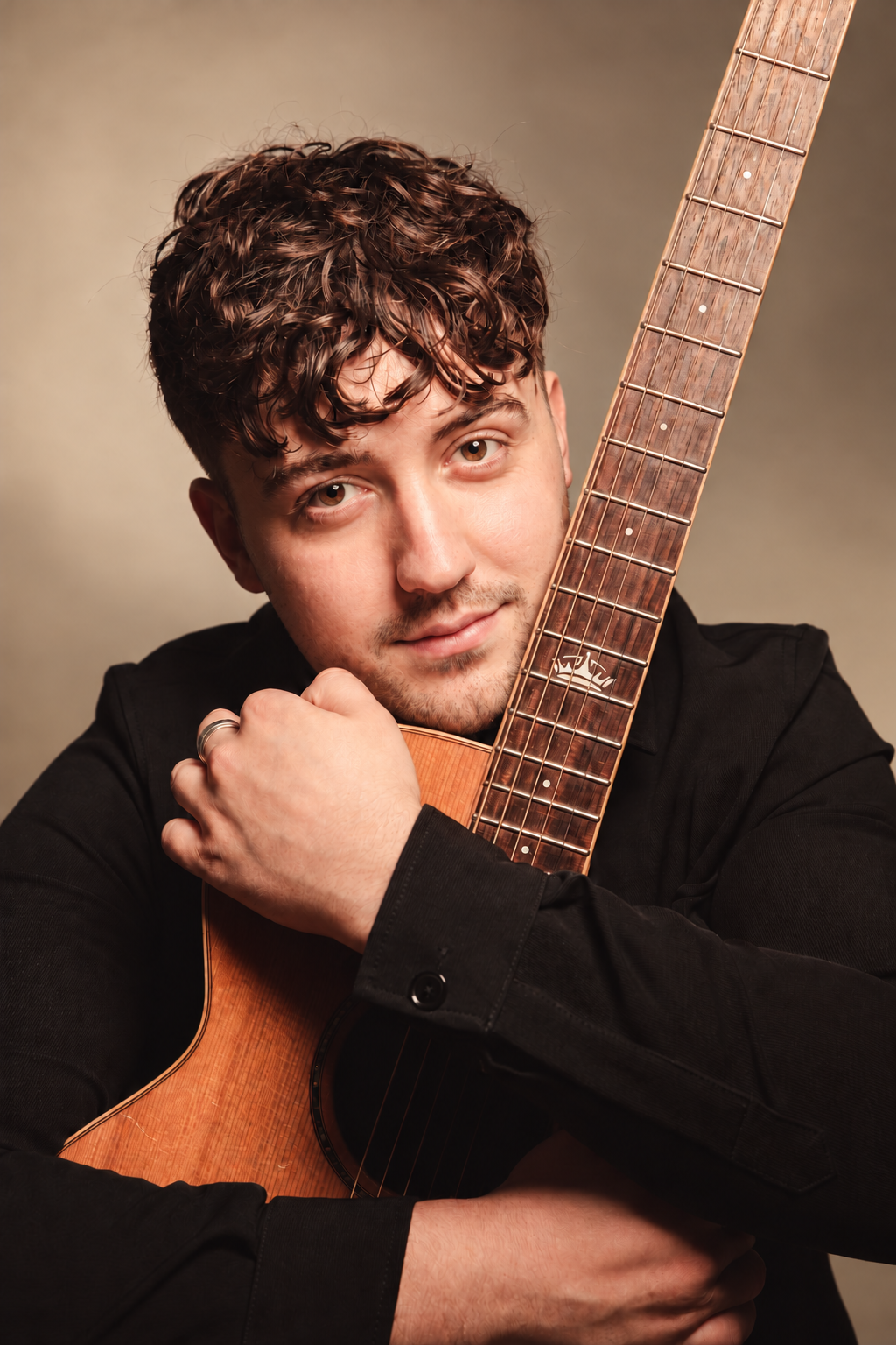 Acoustic musician holding his guitar